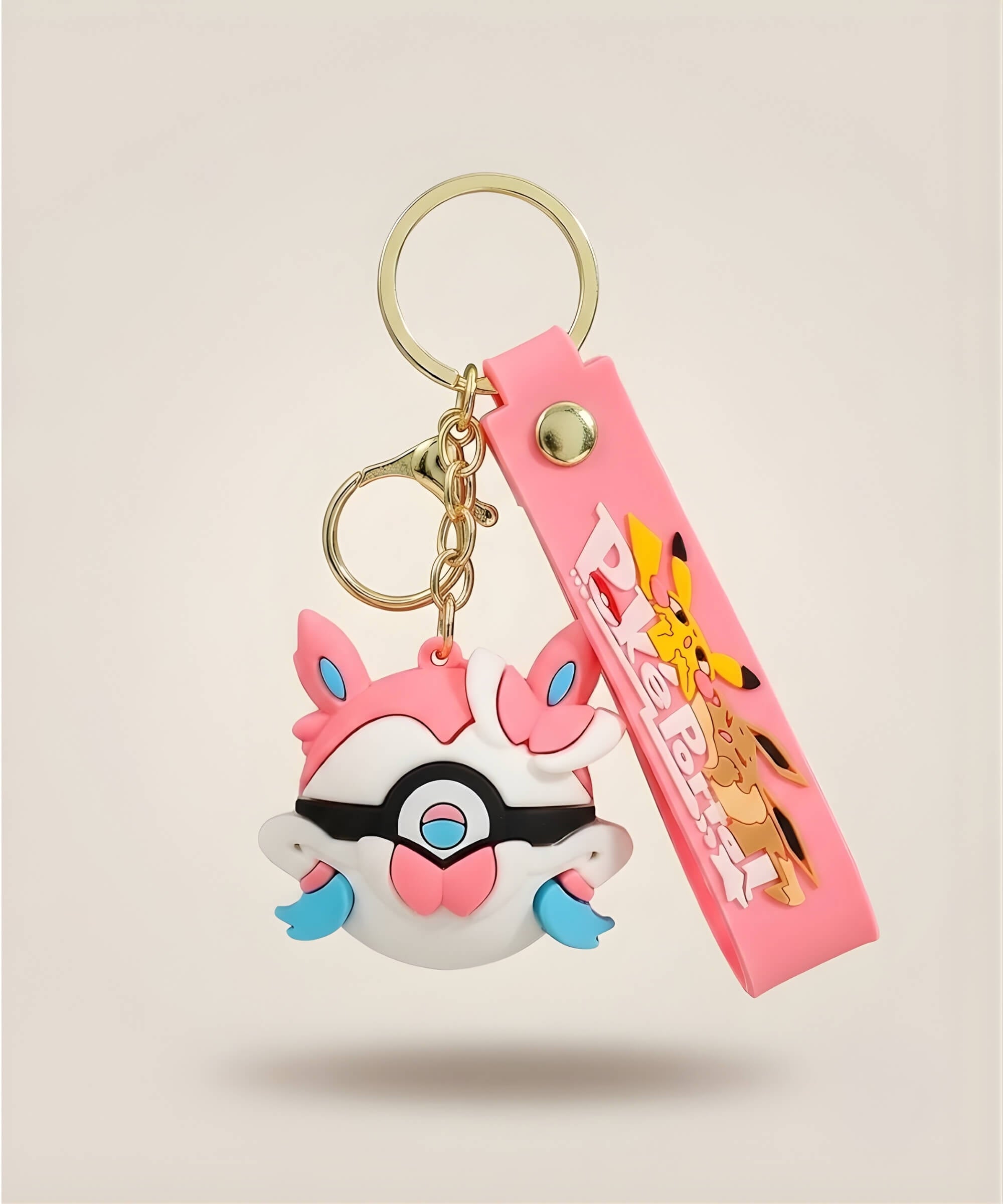 Pink bow Poke Ball-inspired strap keychain with colourful anime-style 3D charm and matching pink wrist strap